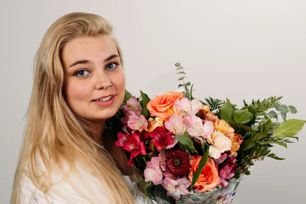 A person holds a bouquet of flowers.