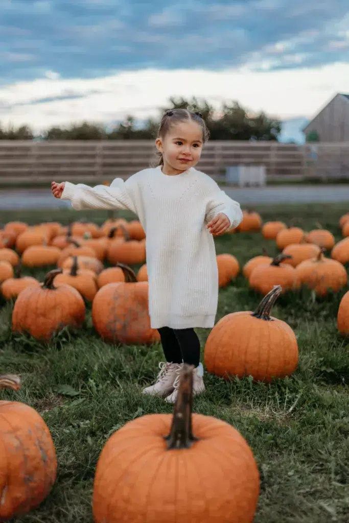 Young Girl Dancing In A Pumpkin Patch