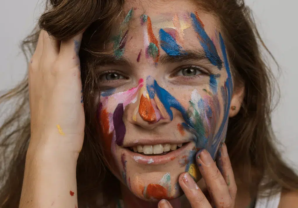 A person's portrait with artfully painted eyelashes and skin in the image.