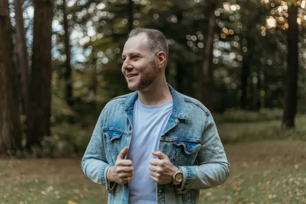 A Person Wearing A Blue Jacket Is Standing For Photograph