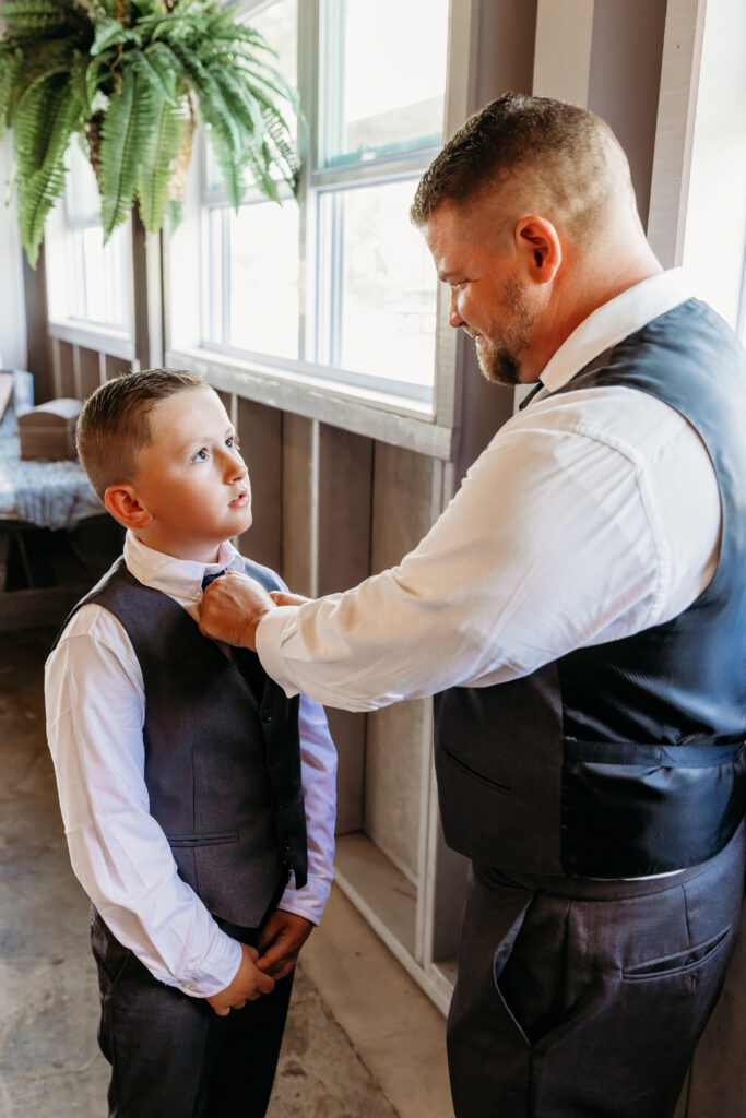 Father and son fixing tie