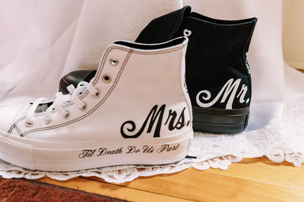 A pair of personalized black and white sneakers labeled